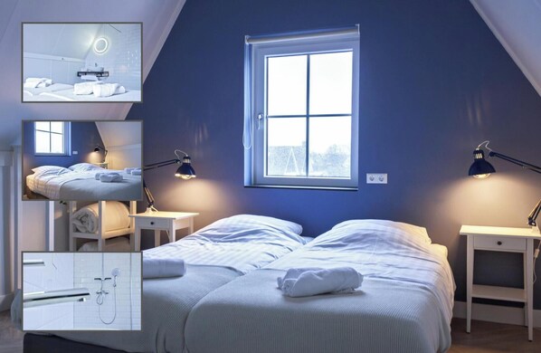 Ein Schlafzimmer mit zwei Betten, einem Fenster und einem Badezimmer mit Dusche.
