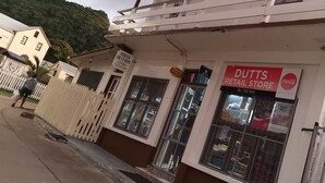 A building with a sign for a 'Heritage Guesthouse' and a 'DUTTS RETAIL STORE'.