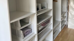 A walk-in closet with open shelving, storage bins, and hanging space. - Apartment 'Nr 1' with Wi-Fi (Schwelm)