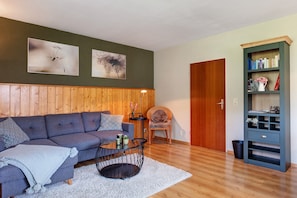 A living room with a sofa, coffee table, and bookshelf.