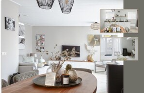 A modern living room with a dining area, featuring a wooden table, a sofa, and a TV. There are decorative items on the table and a bookshelf in the background.