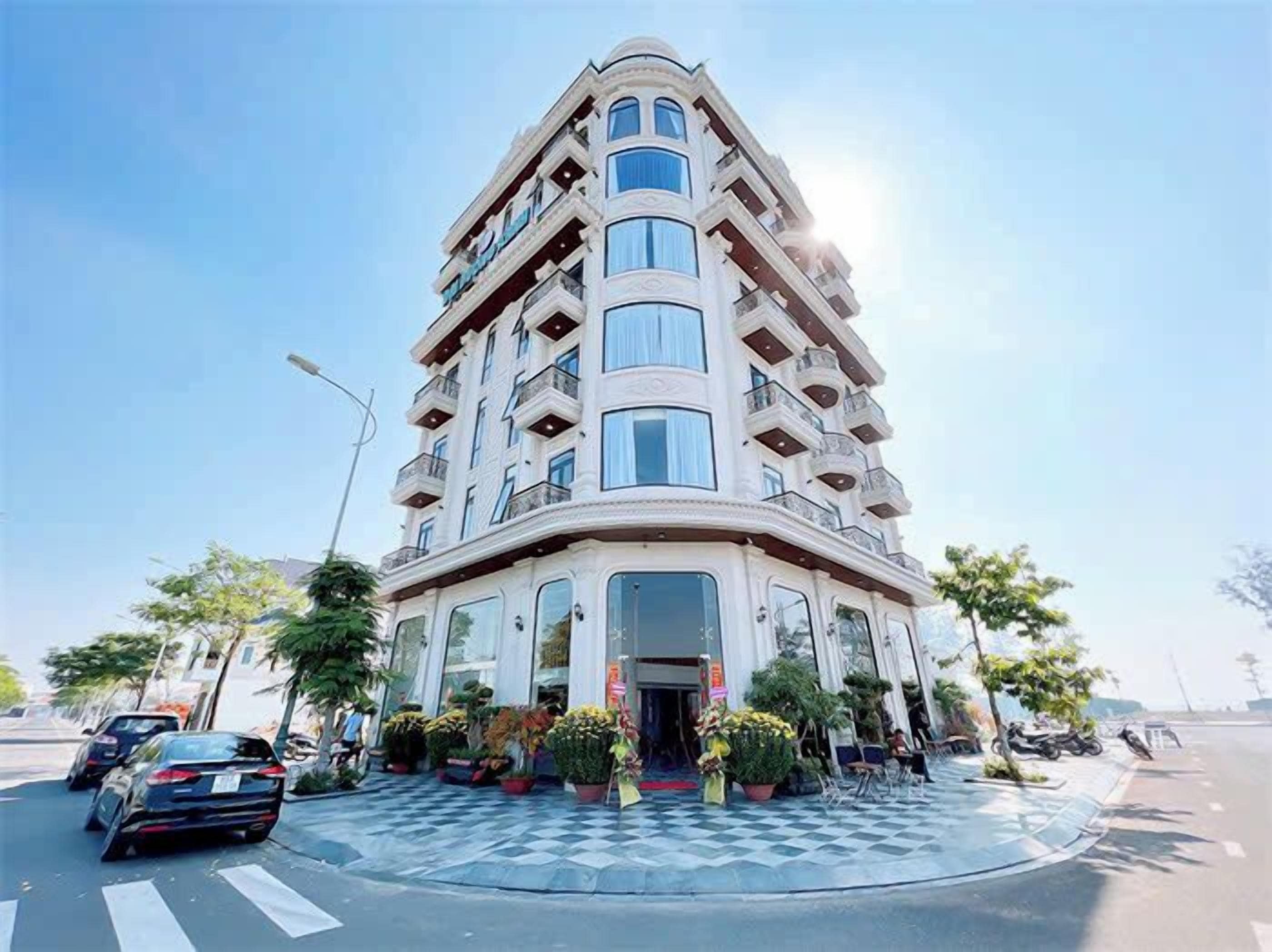 A multi-story hotel with a curved facade, large windows, and balconies.