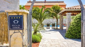 A stone entrance gate with a sign reading "KUČA ZA ODMOŘ" and a palm tree in the foreground. - Villa Tina Pula, Šišan, 3.8km from beach, modern mediterranean, pool, grill (Šišan)