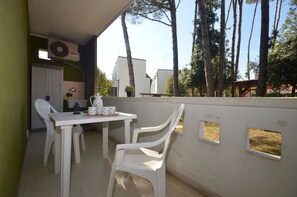 Relax on the patio with a warm cup of tea, surrounded by lush greenery and a tranquil atmosphere.