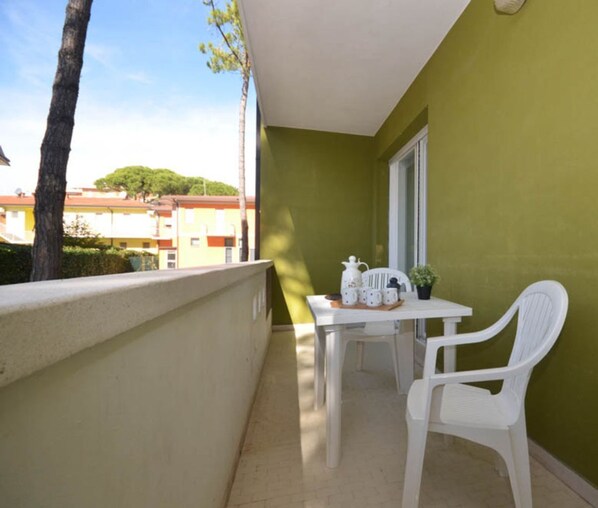 Enjoy a peaceful retreat on the balcony with a tree-lined view.