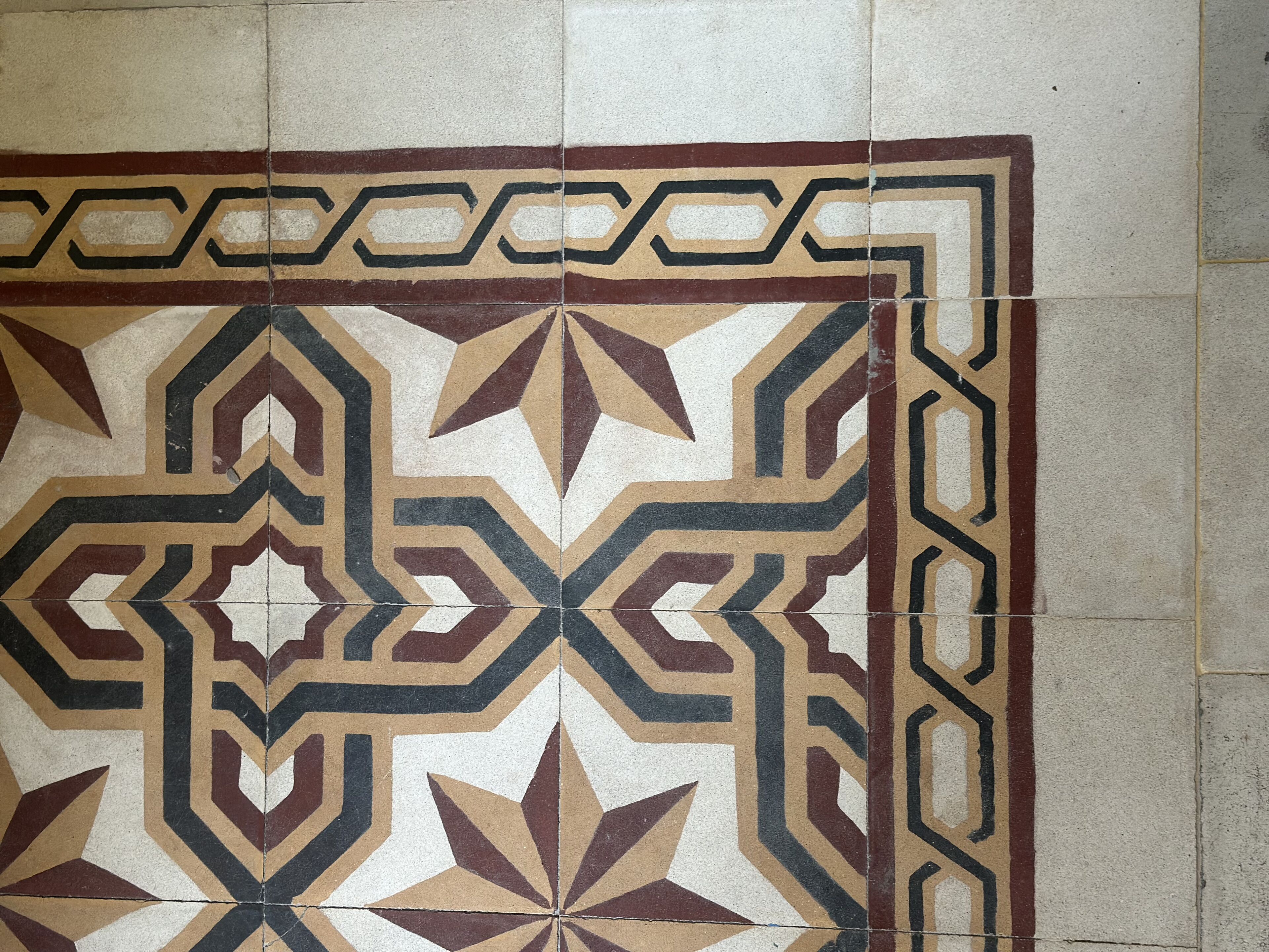 A tiled floor with a geometric pattern.
