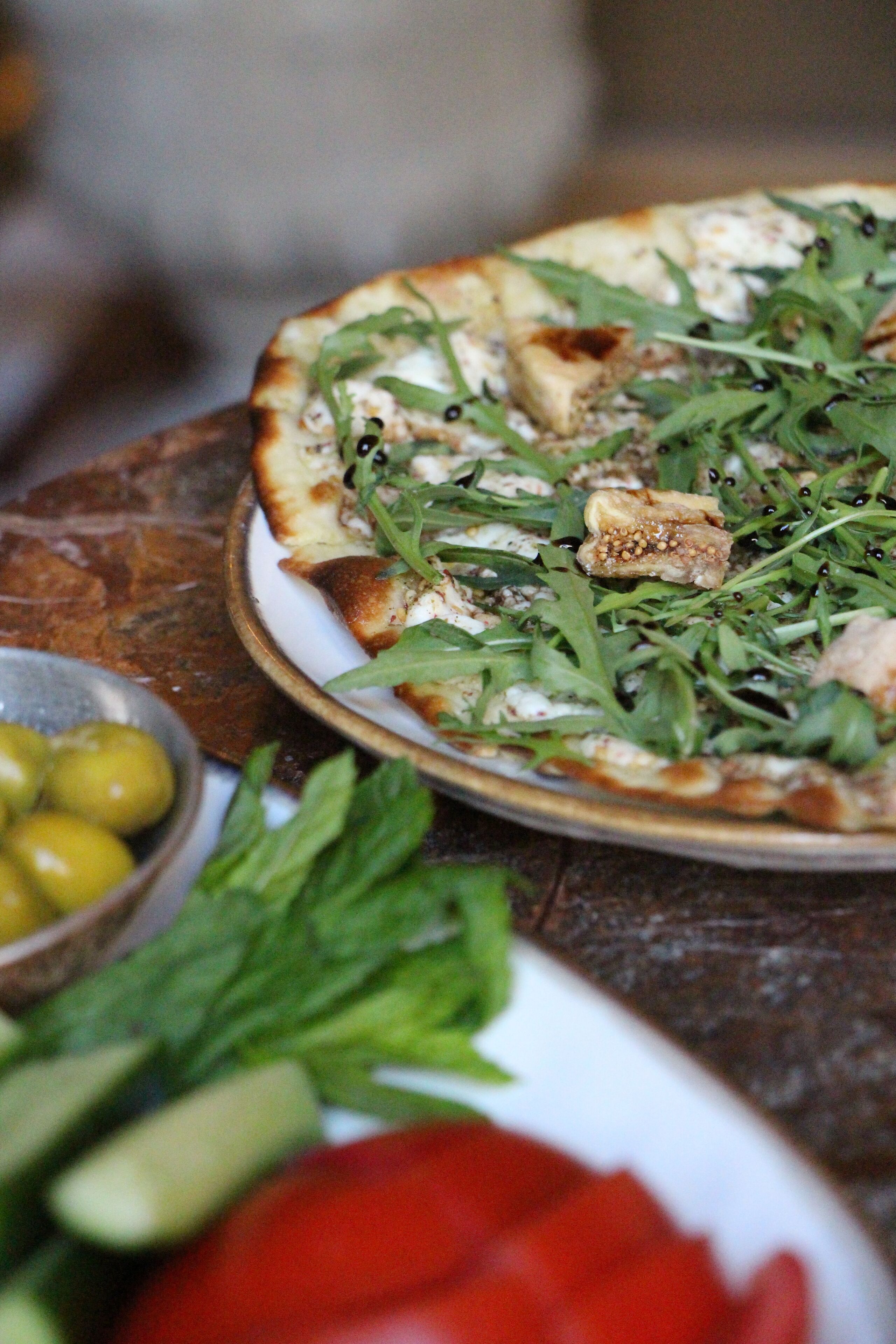 A pizza with toppings on a plate.