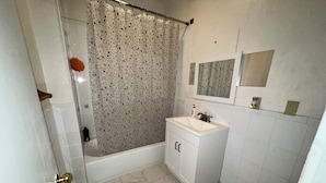 A bathroom with a bathtub, a sink, and a toilet.