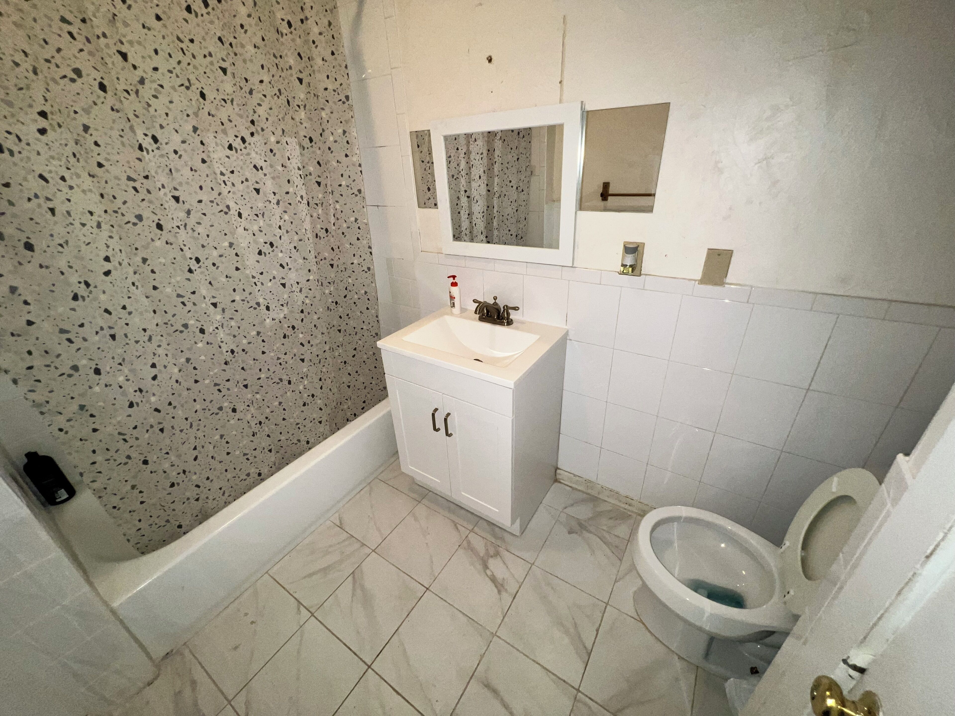 Combined shower/bathtub, soap, toilet paper