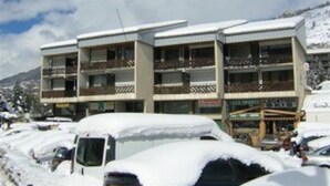 A multi-story building with balconies, surrounded by snow-covered cars. - Duplex 6 Guests, Near Ski Slopes, Balcony, Pet-Friendly (Saint-Chaffrey)