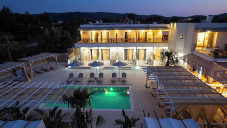 Una piscina al aire libre de temporada, sombrillas