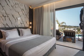 Ein Hotelzimmer mit Bett, Blick auf den Pool und einem Balkon mit Stühlen.