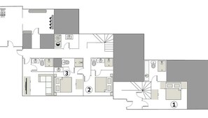 Distribución de un hotel con tres espacios diferenciados, una kitchenette y un baño.