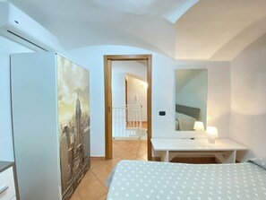 Relax in a stylish room with a comfortable bed, desk, and mirror.