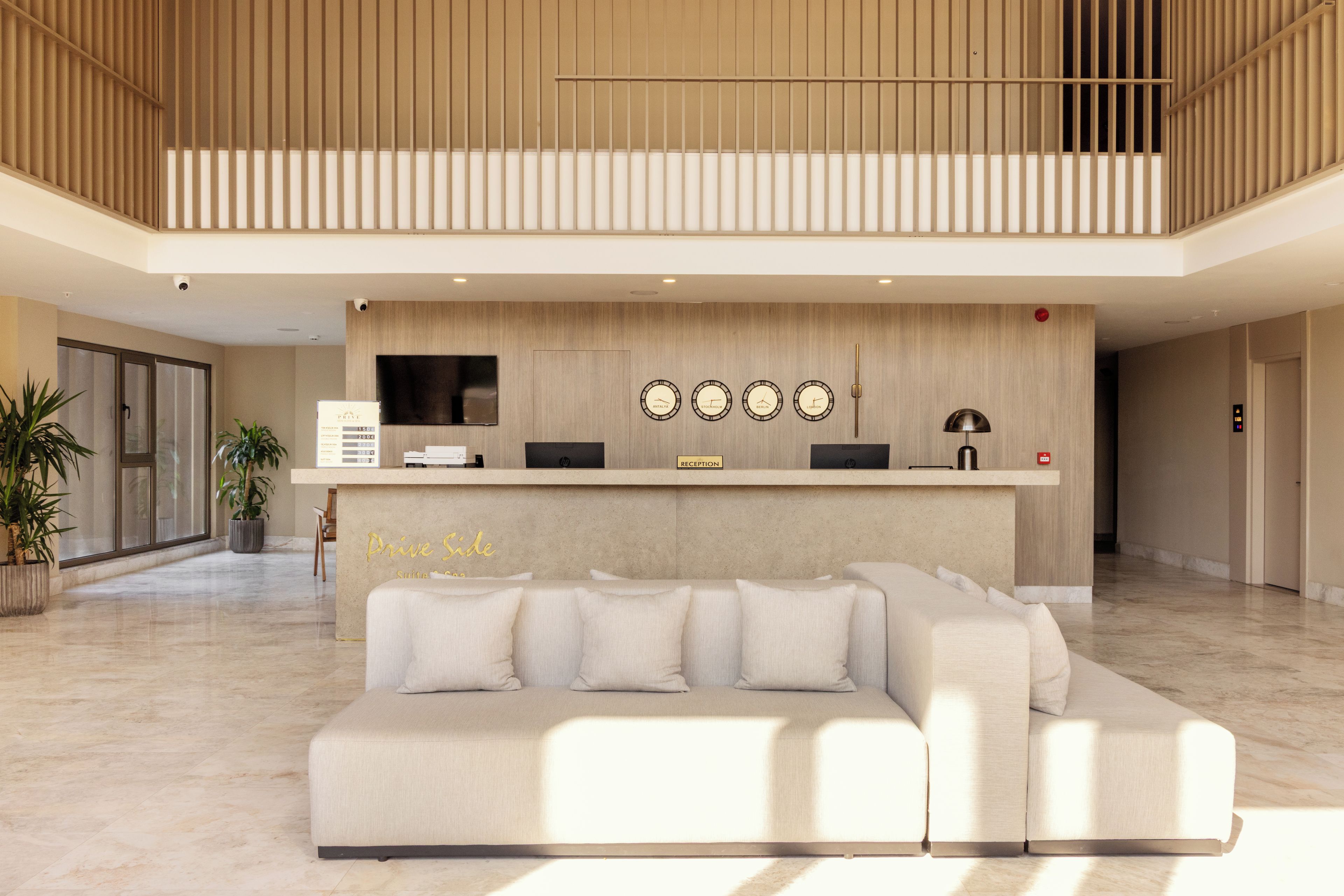 A reception area with a reception desk, a sofa, and a wall-mounted clock.