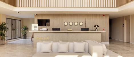 A reception area with a reception desk, a sofa, and a wall-mounted clock.
