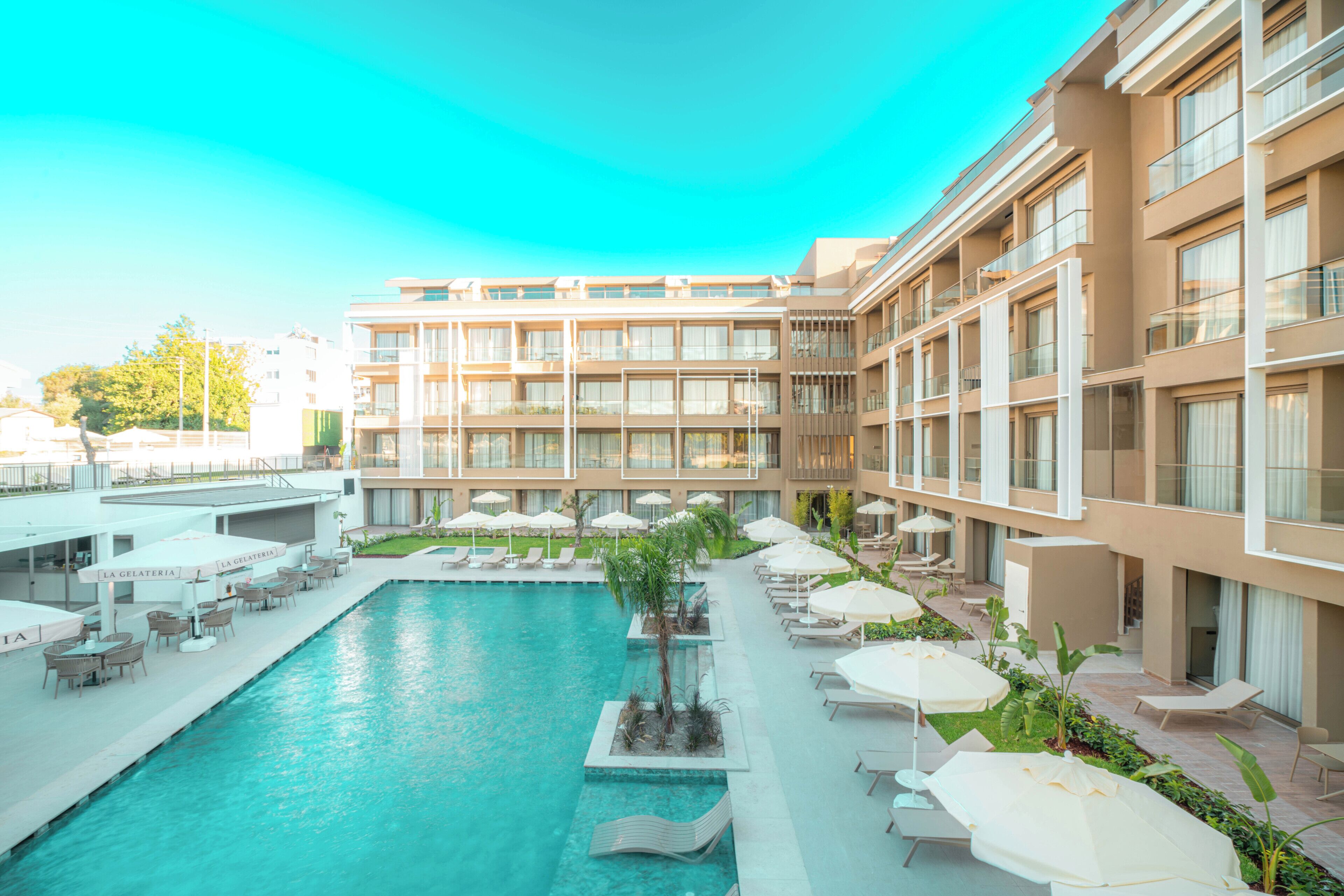 Seasonal outdoor pool, open 7:30 AM to 7:30 PM, pool umbrellas