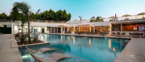 Seasonal outdoor pool, open 7:30 AM to 7:30 PM, pool umbrellas