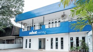 A two-story building with a blue and white facade, featuring a sign that reads "rehot Pastel Pelangi." - Rehat at Paskal Pelangi (Bandung)