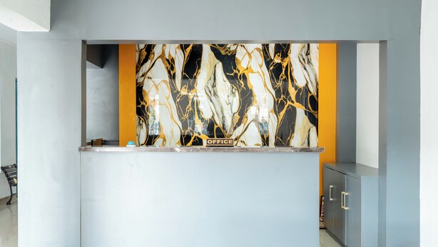 A reception desk with a marble backsplash and a sign that reads "OFFICE". - Rehat at Paskal Pelangi (Bandung)