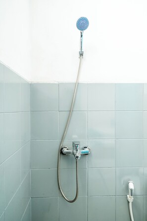 A shower with a handheld showerhead and a handheld hose.