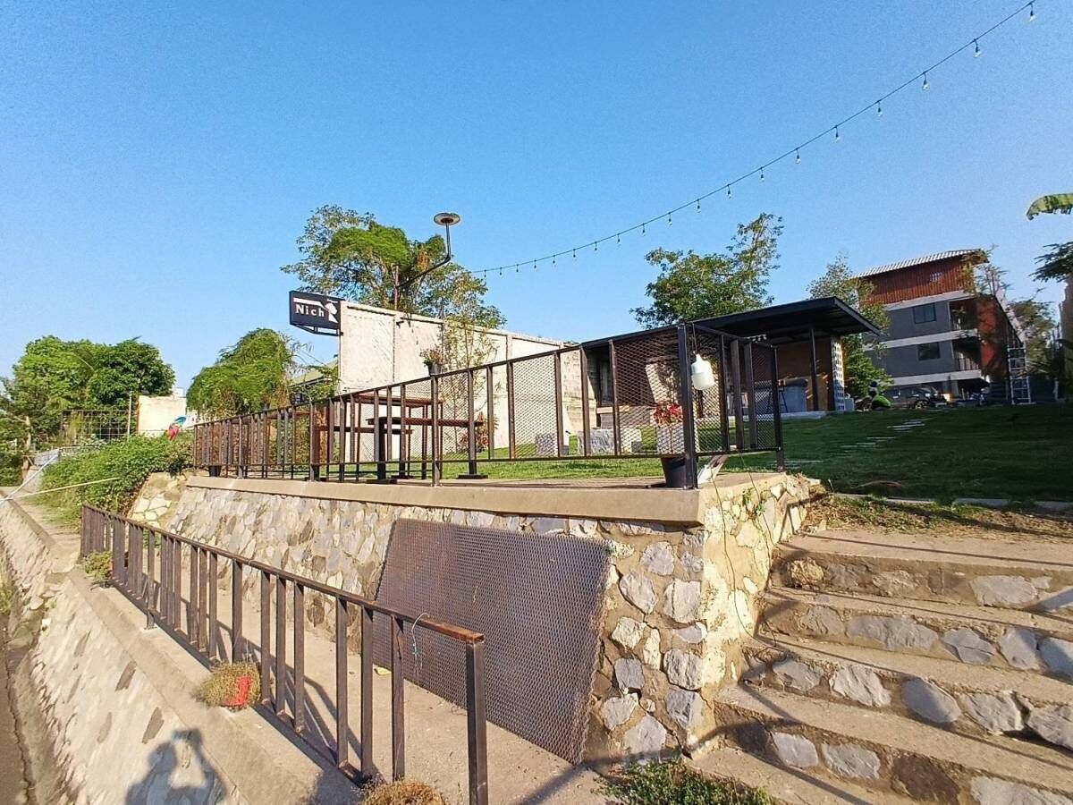 A stone staircase leading to a covered outdoor area with a metal railing.