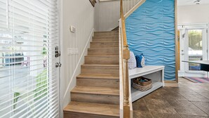 A staircase with wooden steps and a blue textured wall at the top. - Perfect Beach House 2min Walk With Heated Pool and Hot Tub 4 bed 3 Bath With Pet Friendly (Palm Coast)
