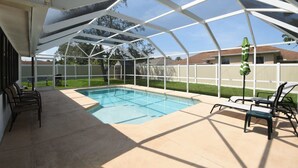 A covered outdoor swimming pool with a glass roof, surrounded by lounge chairs and a patio area. - Hidden Oasis Spacious Home With Salt Water Heated Pool Hot Tub Fenced Yard Pets are Welcome (Palm Coast)