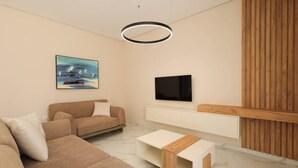 Ein modernes Wohnzimmer mit einem beige farbenen Sofa, einem Flachbildfernseher, einer Wandpaneele aus Holz und einer Deckenleuchte.