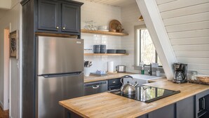 A modern kitchen with a stainless steel refrigerator, wooden countertop, and a kettle. - Chalet on Ski Mountain - Stunning Views of Mount LeConte - Right in Gatlinburg! (Gatlinburg)