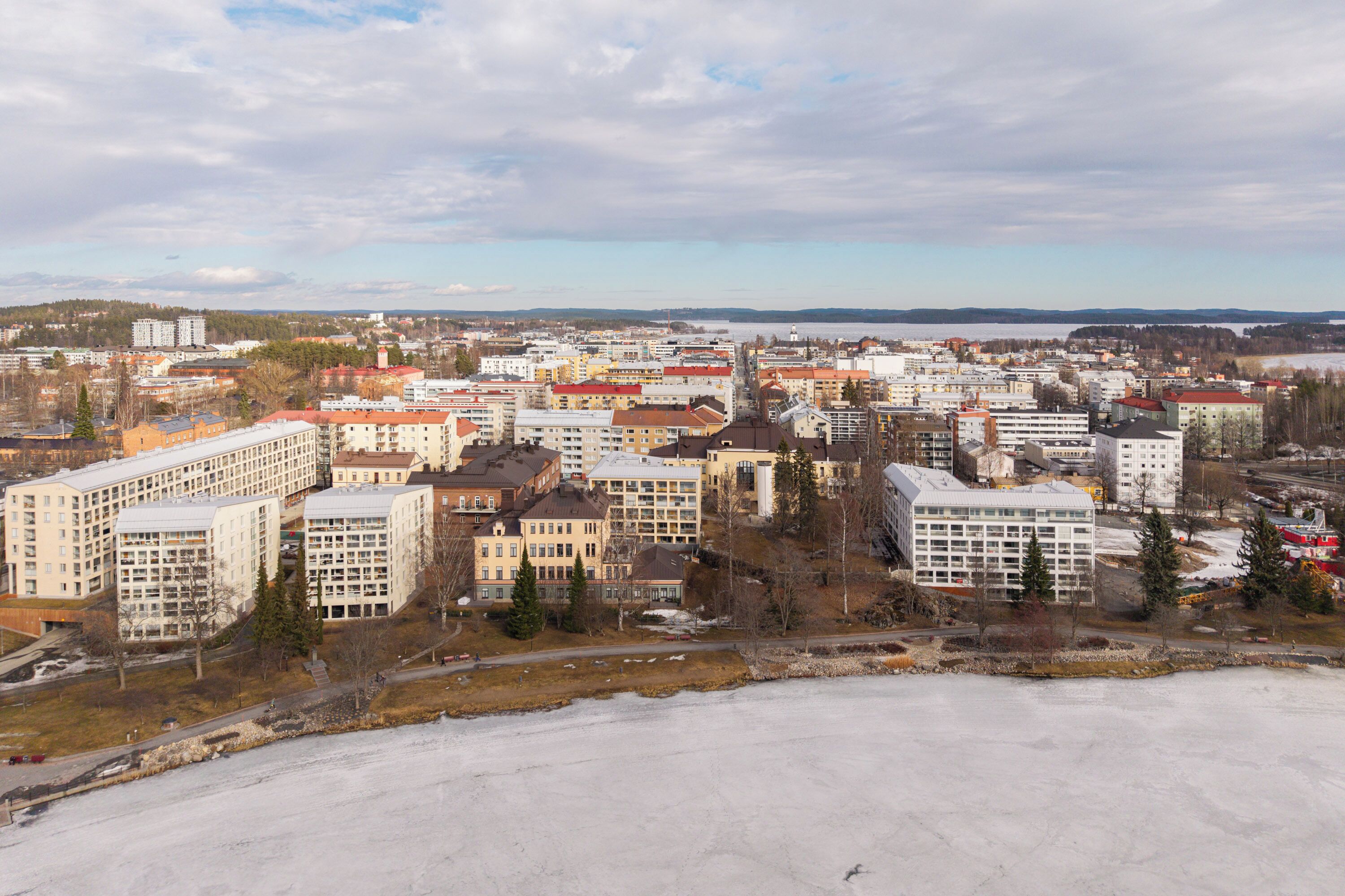 A cityscape with various buildings, including multi-story residential and commercial structures.