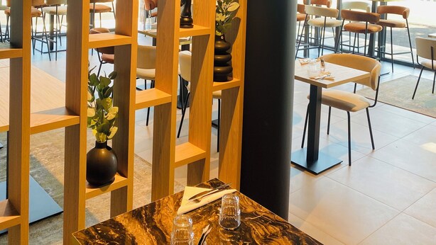 A modern interior with a wooden partition, marble table, and seating area. - Nemea Appart Hotel Strasbourg Illkirch (Illkirch-Graffenstaden)