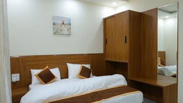 A modern bedroom with a wooden bed, a ceiling fan, a large mirror, and a nightstand.