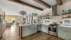 A spacious kitchen with wooden beams, a central island, and a built-in oven. - 6-Seater LSV & Bikes Included! Private Pool, 2 Kings, Pet Friendly! Seagrove Eastern Lake! (Santa Rosa Beach)