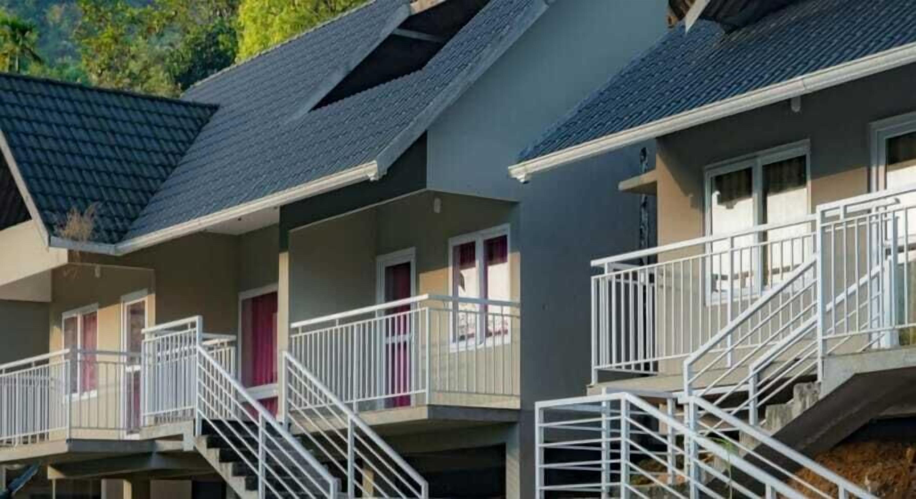 A multi-story residential building with balconies and external staircases.