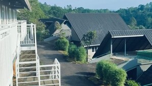 A residential area with multiple houses featuring sloped roofs and a central pathway. - Rains Valley Resort By Teal Luxury Stays (Devikolam)