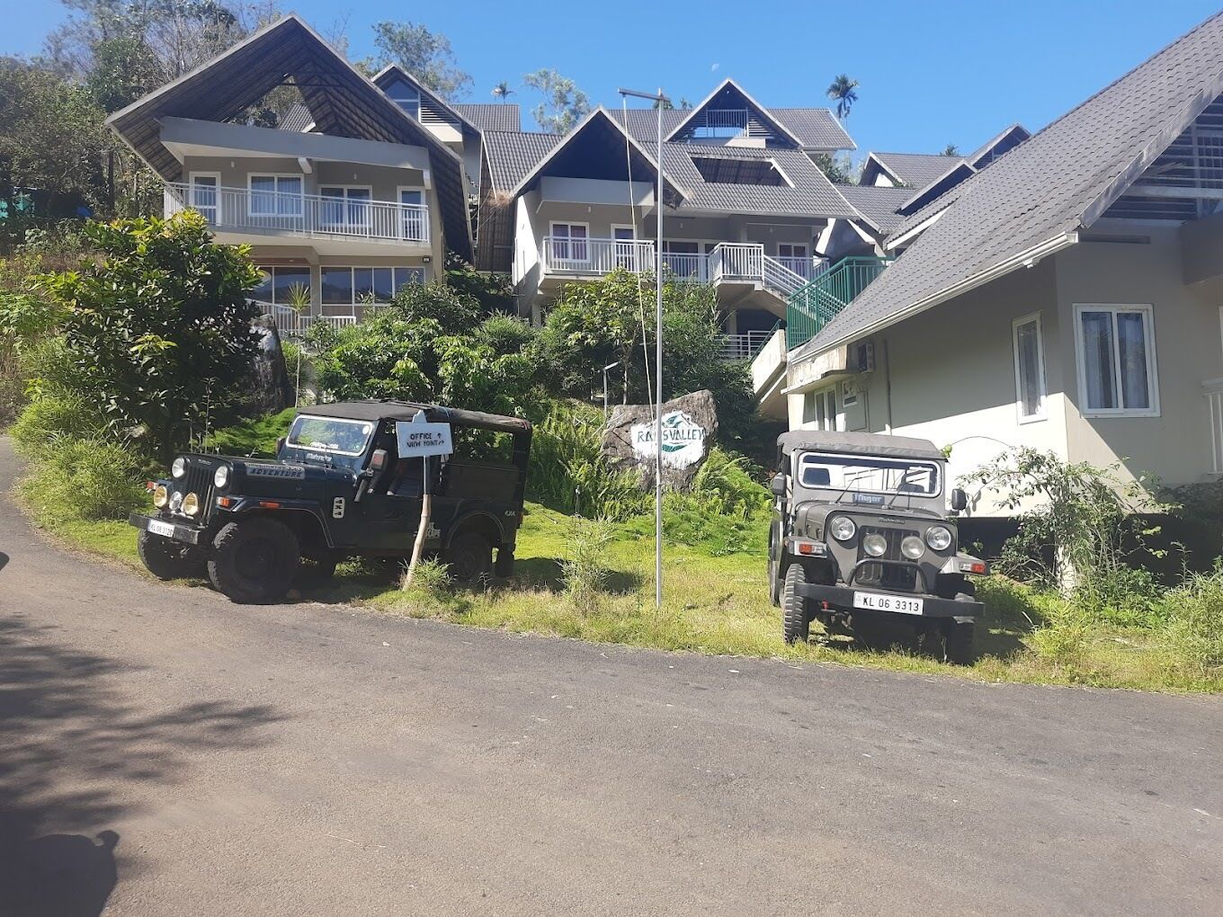 A row of two-story houses with a sign indicating an office and viewing point.