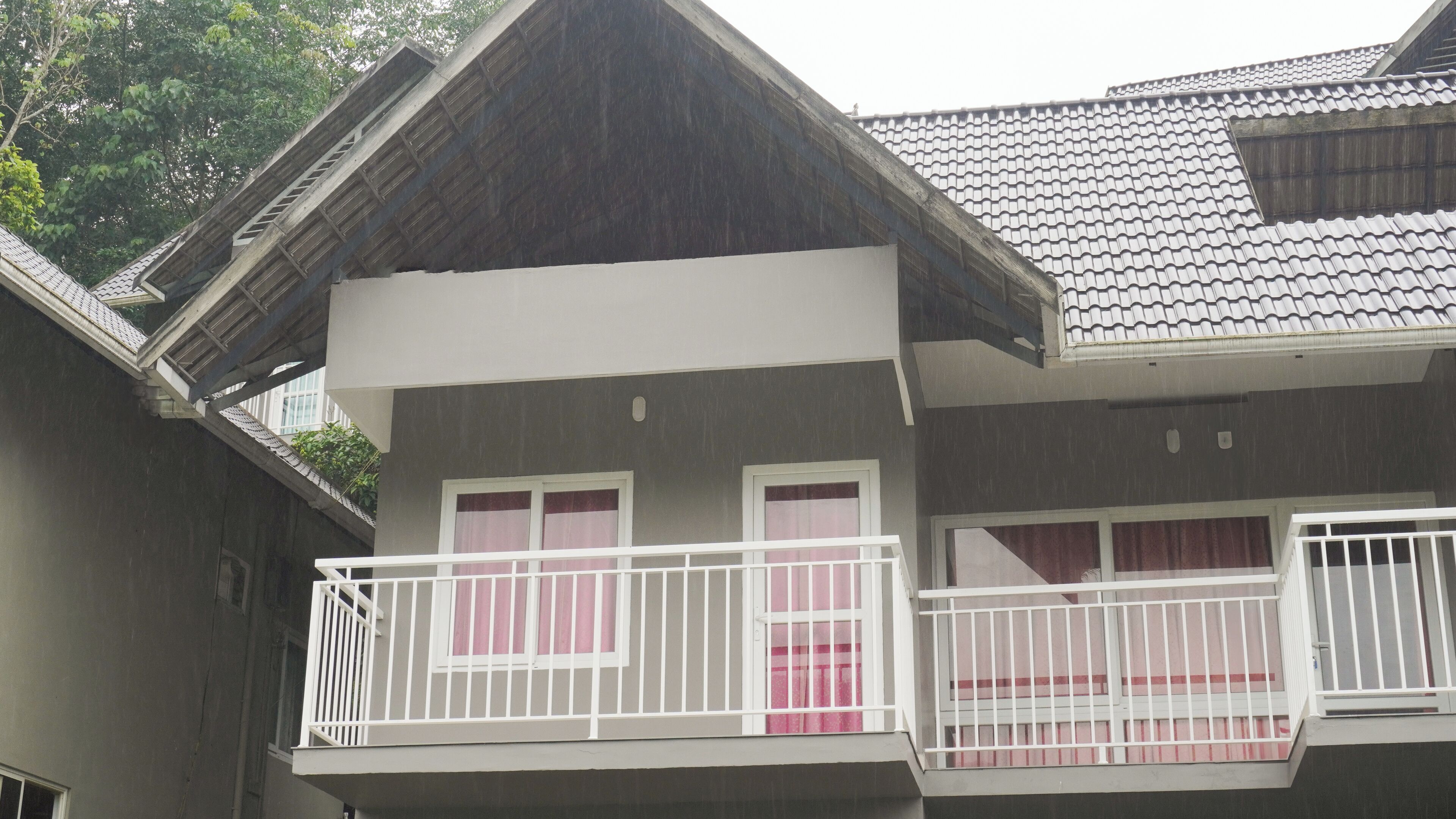 A two-story building with a balcony on the second floor.