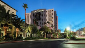A high-rise hotel named 'Platinum' with a modern design, surrounded by palm trees and well-lit streets. - Sphere View, Near Dining & Nightlife: Luxe Condo (Las Vegas)