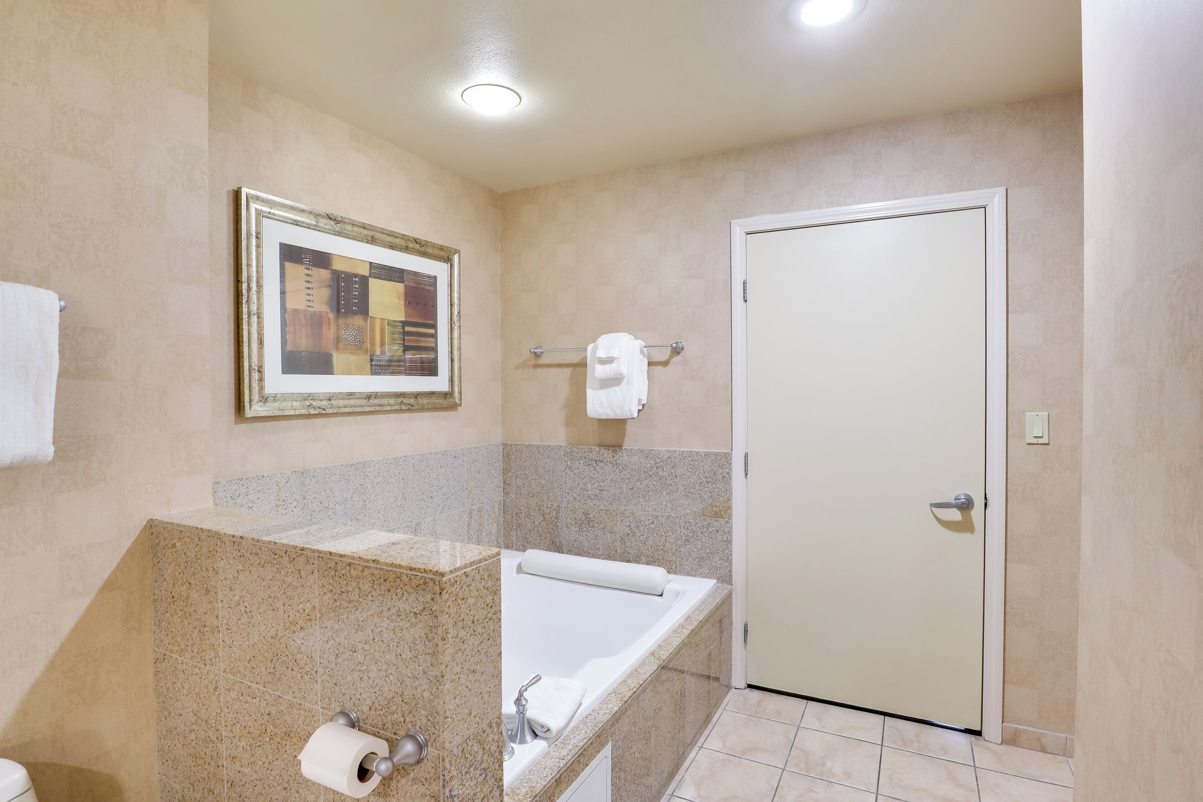A bathroom with a bathtub, toilet, and sink.
