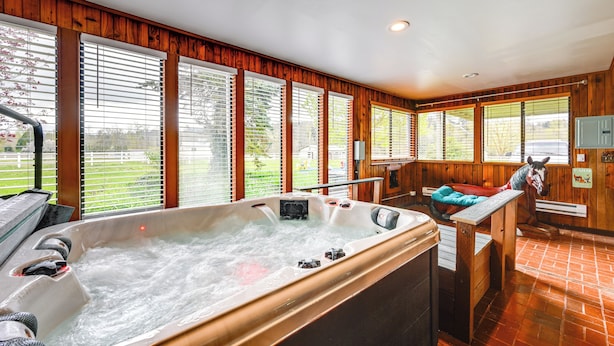 A hot tub with a wooden interior, large windows, and a horse statue. - 9 Mi to Spanaway Park: Home w/ Indoor Hot Tub (Spanaway)