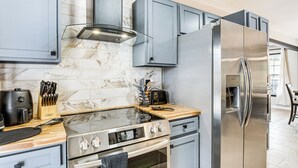 A modern kitchen with a stainless steel refrigerator, double oven, and a built-in stove. - 4 Mi to Airport: Atlanta Home w/ Deck & Hot Tub (Atlanta)