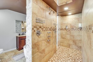 A modern bathroom with a shower, a vanity, and a toilet. - Fire Pit + Game Room: Spacious Poconos Retreat! (Long Pond)