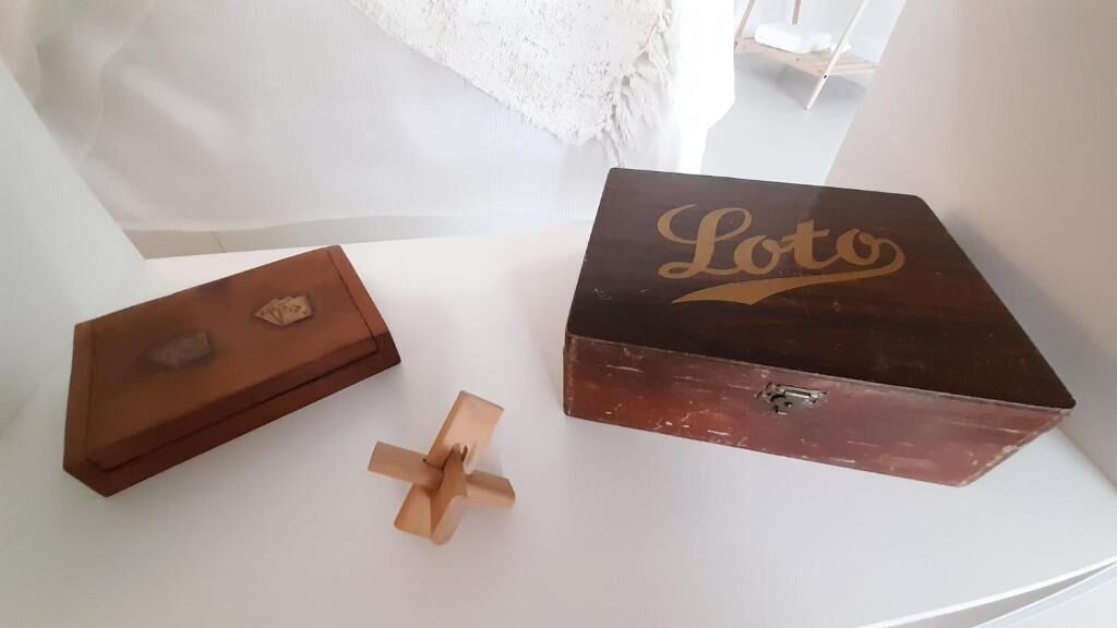 A wooden box with the word "Loto" on it, placed on a white surface.