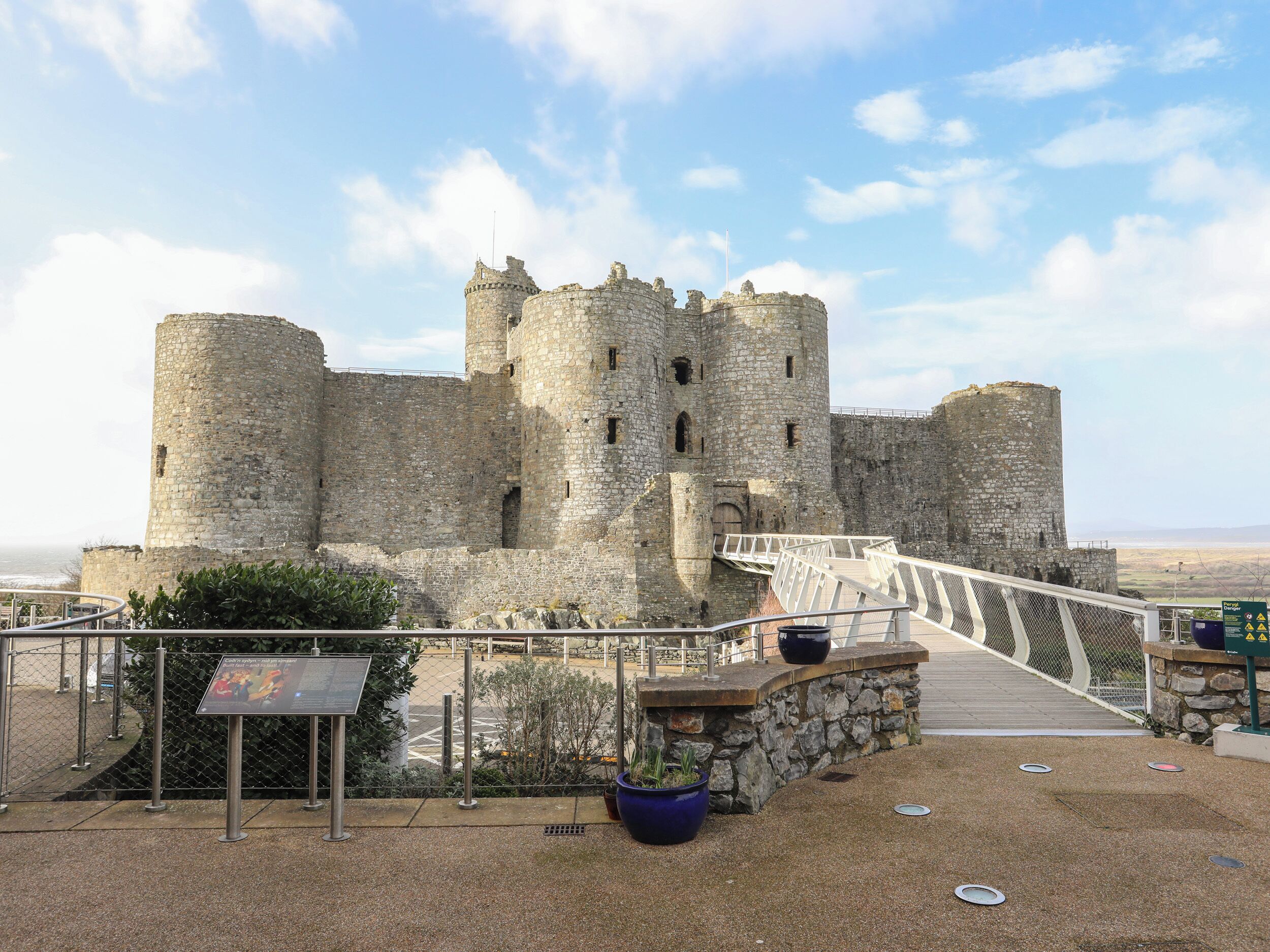 A historic stone castle with a bridge leading to the entrance.