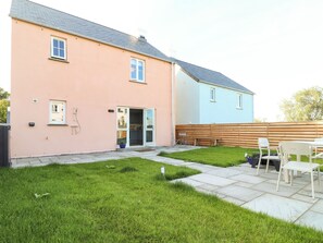 A two-story house with a patio area.
