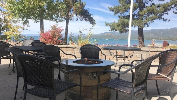 An outdoor seating area with a fire pit, wicker chairs, and a view of the lake and mountains. - Llc1236 - Lakeside Landing 4 Bedroom Condo (South Lake Tahoe)