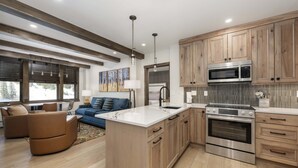 A modern kitchen with wooden cabinets, stainless steel appliances, and a central island.