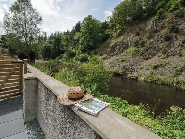A concrete ledge with a woven hat and a magazine.