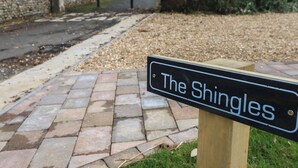 A sign reading "The Shingles" on a wooden post. - The Shingles (Sandown)